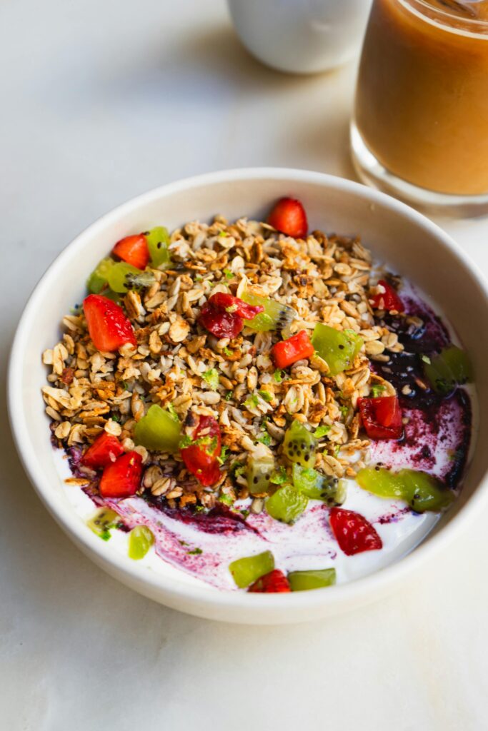 Healthy Weight Loss Breakfast: Yogurt bowl with granola, strawberries, kiwi, and blueberries